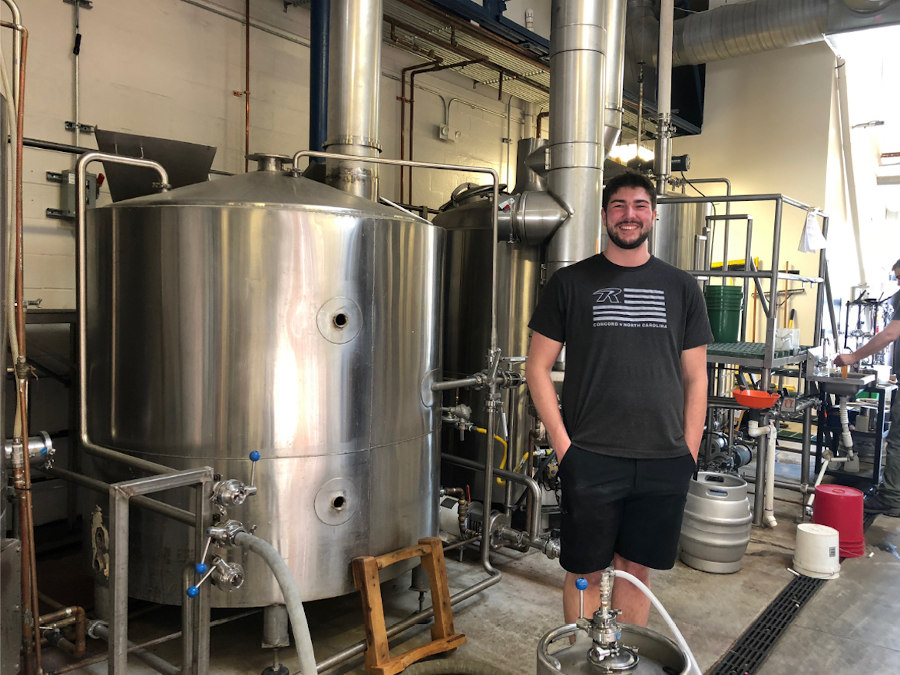 RideNow Concord Inventory Manager, Tristan, at Catawba brewery assisting with the brewing process of the RideNow IPA.